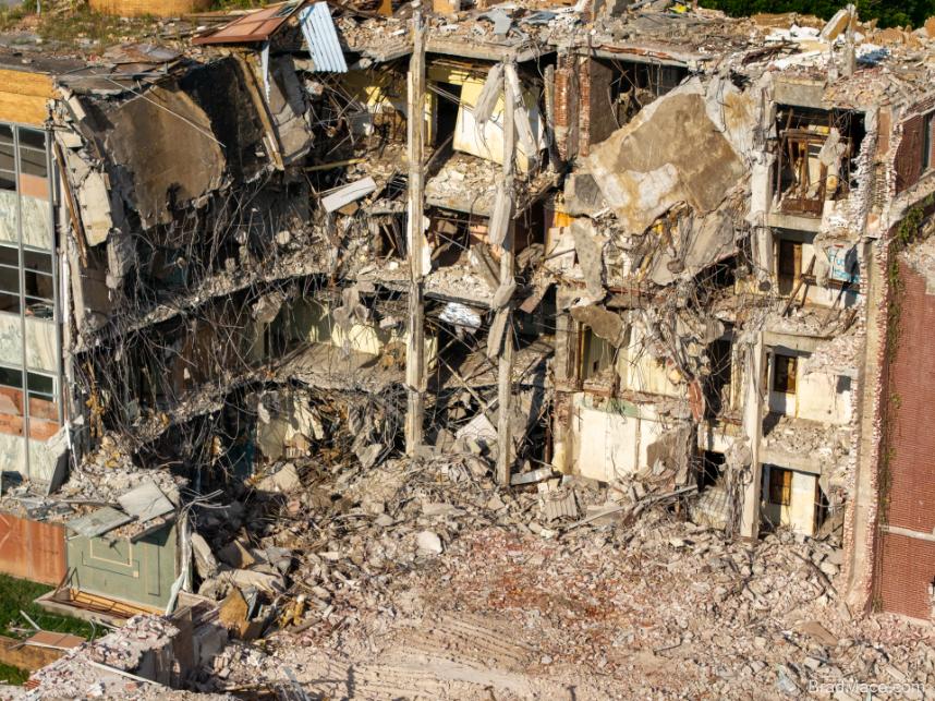 Aerial view of severely demolished multi-story building
