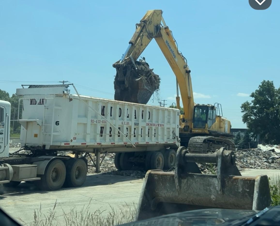 Midland Wrecking excavator loading debris into dump truck