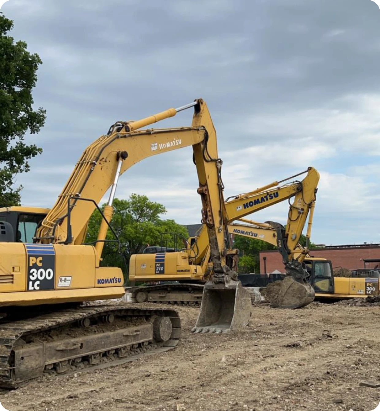 Three Komatsu excavators parked at Midland Wrecking equipment yard